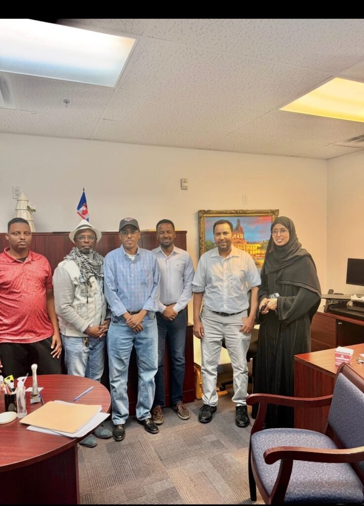 Seven community members standing together in a government office during an advocacy meeting