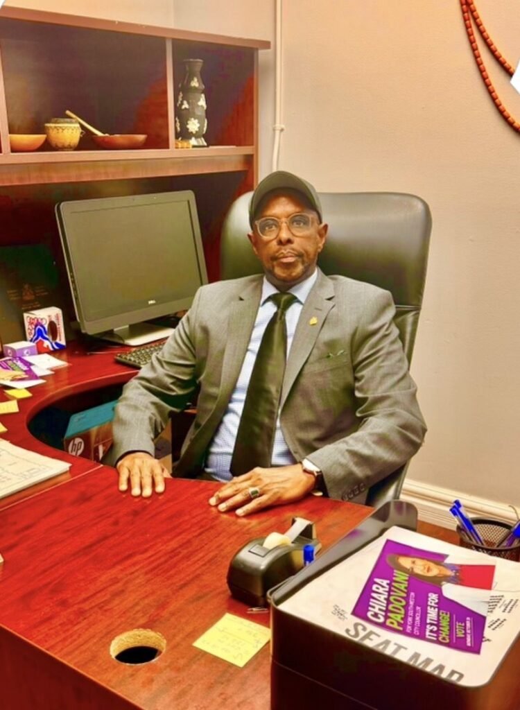 Ibrahim Shurie, chairman of the Somali Community of Edmonton Society, seated at his office desk